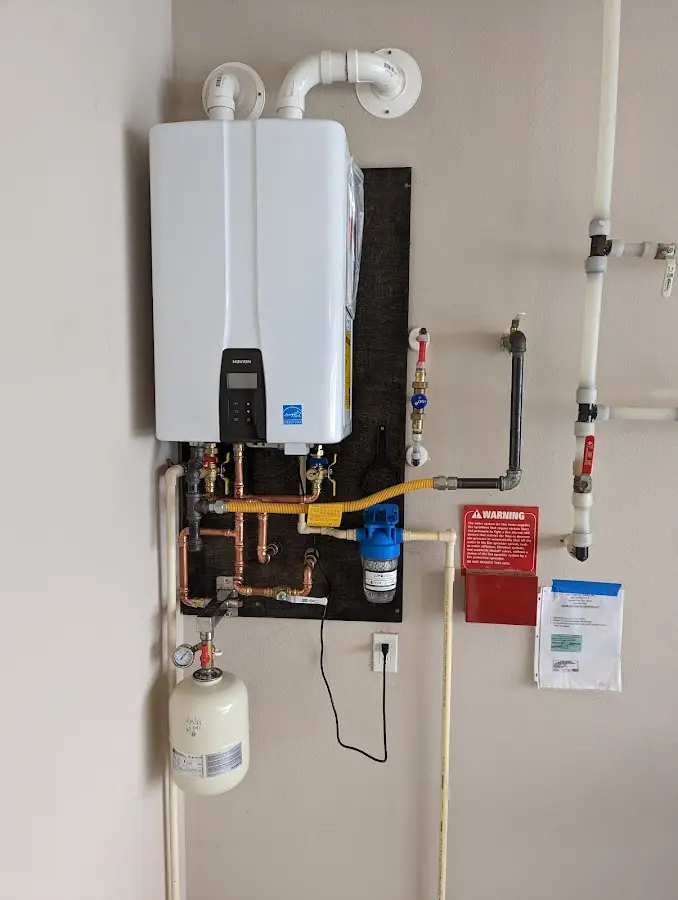 Professional plumber installing copper piping in a Jennings home